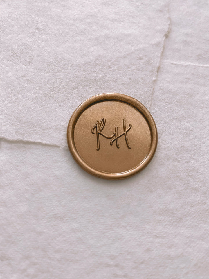 Calligraphy script monogram round gold custom wax seal on white handmade paper envelope