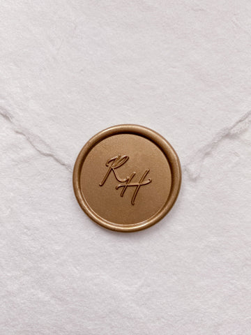 Calligraphy script monogram round gold custom wax seal on beige handmade paper envelope
