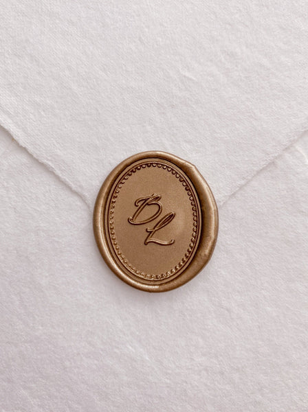 Calligraphy script monogram with border design oval gold custom wax seal on beige handmade paper envelope