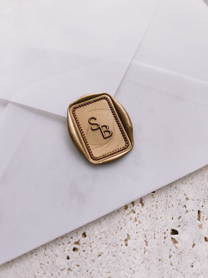 Border monogram rectangular custom wax seal in gold on white paper envelope