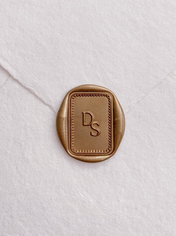 Monogram with border design rectangular gold custom wax seal on beige handmade paper envelope