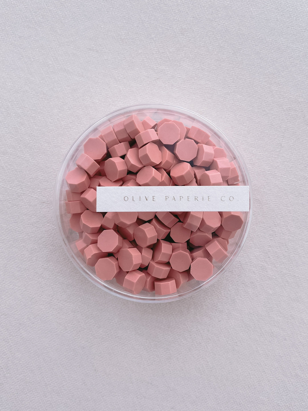 coral pink-orange sealing wax beads in a clear container box