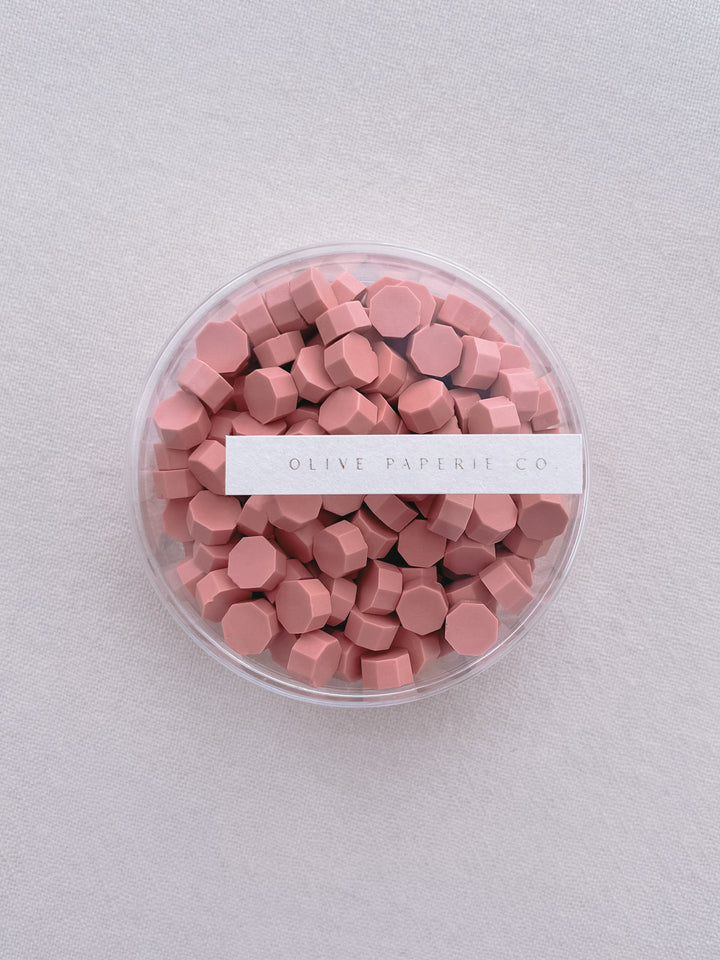 coral pink-orange sealing wax beads in a clear container box