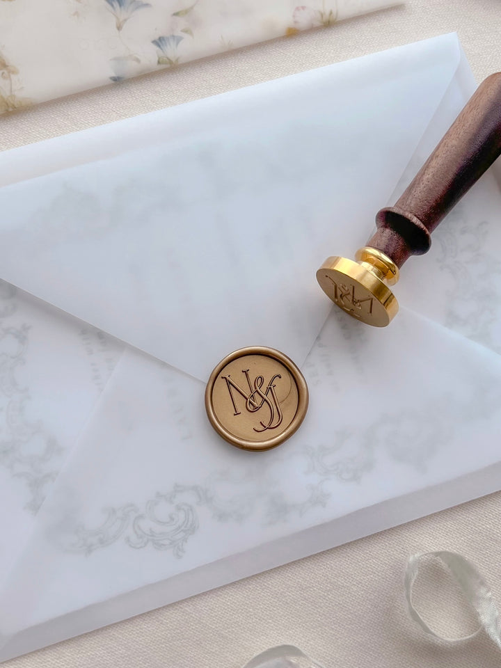 Custom logo gold wax seal with initials on a vellum envelope 