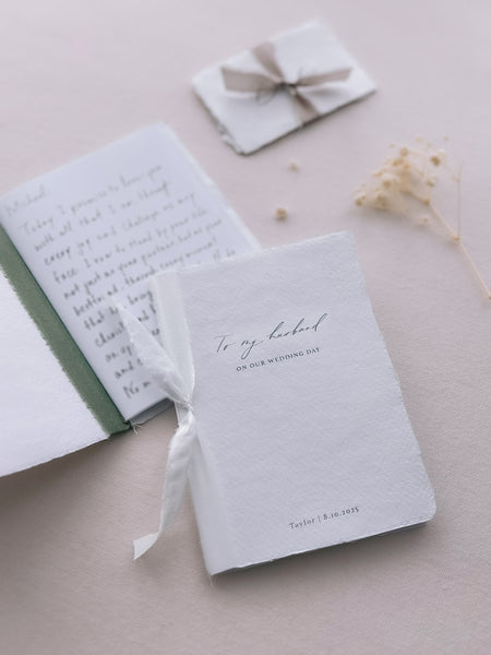 white handmade vow books with personalized names and date