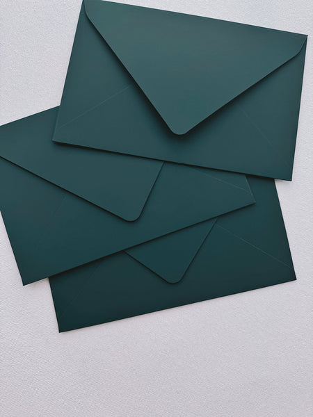 three dark green envelopes