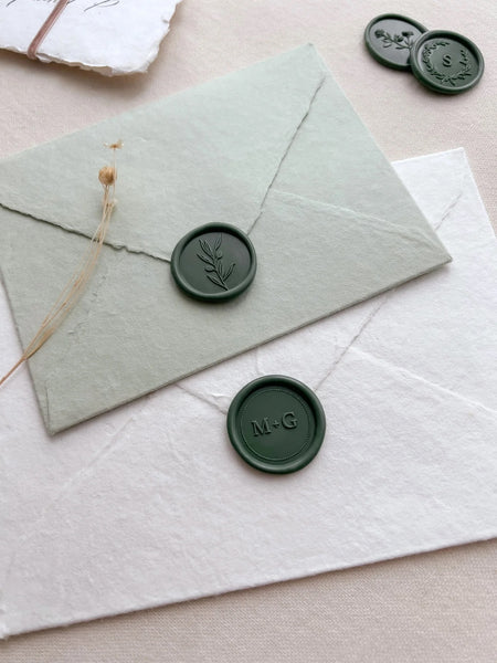 Dark green olive branch wax seal and dark green custom monogram wax seal with personalized initials and a dotted border