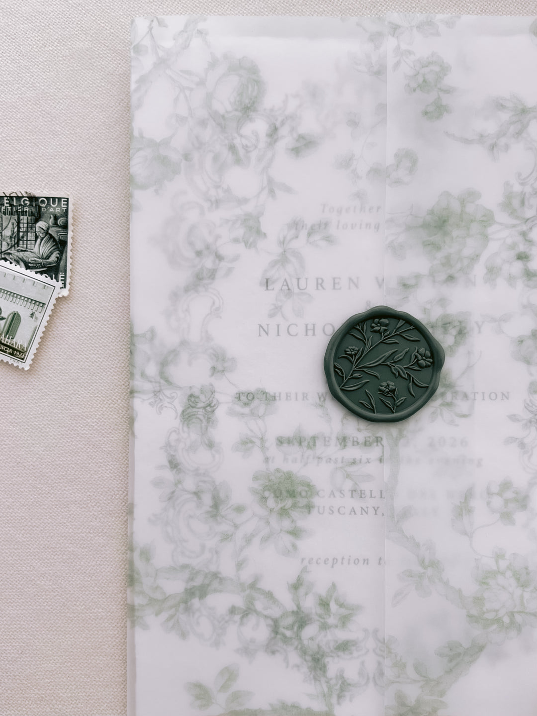 Dark green floral design wax seal on a green floral print vellum jacket