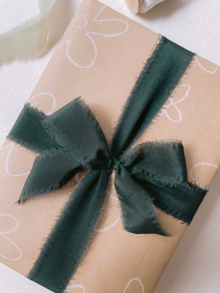 dark green silk ribbon wrapped around Christmas gift