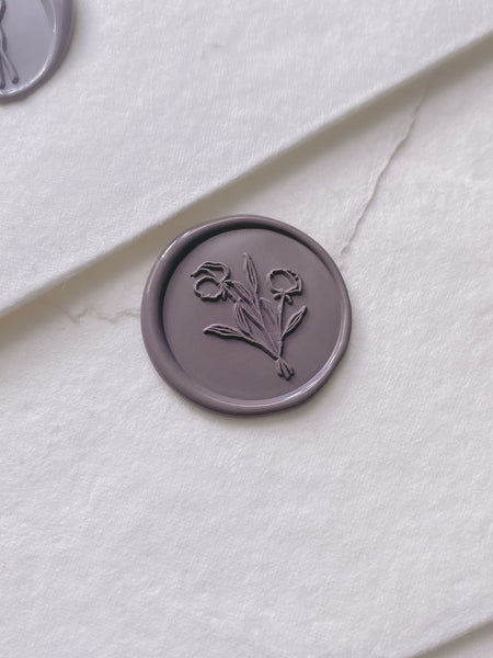 Flower bouquet wax seal in dark purple on handmade paper envelope