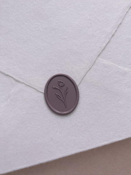 dark purple simple oval flower wax seal on handmade paper envelope