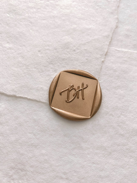 Monogram diamond custom wax seal in gold on handmade paper envelope