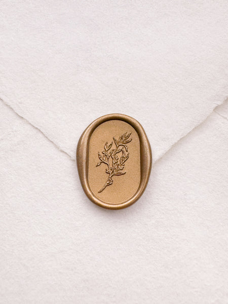 Arch shaped oval botanical leaf design gold wax seal on a white handmade paper envelope