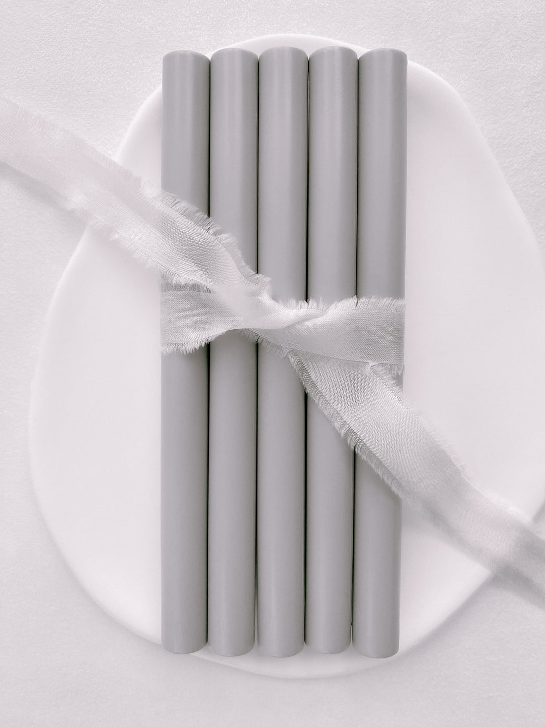 a set of 5 sealing wax sticks in light gray