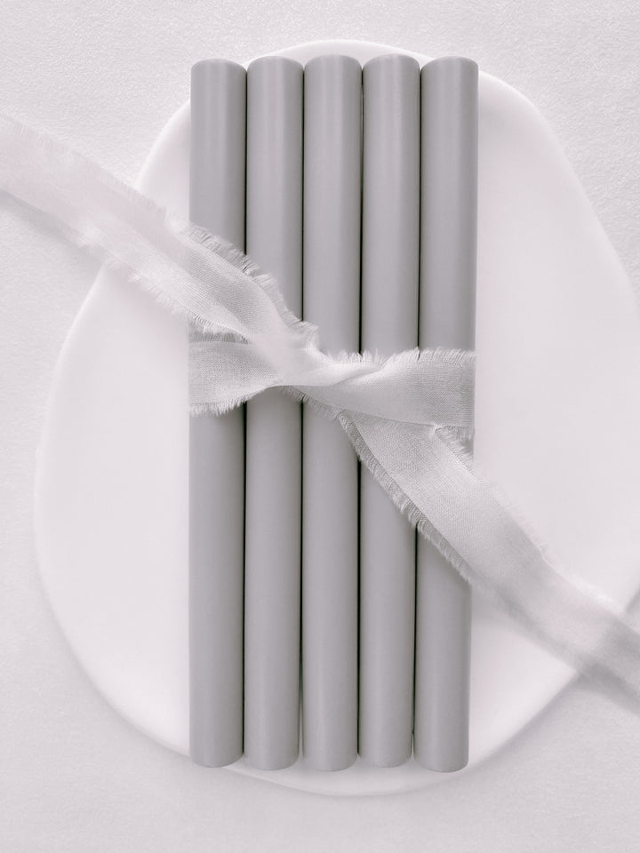 a set of 5 sealing wax sticks in light gray