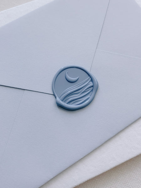 3D moonlight wax seal in dusty blue on blue paper envelope