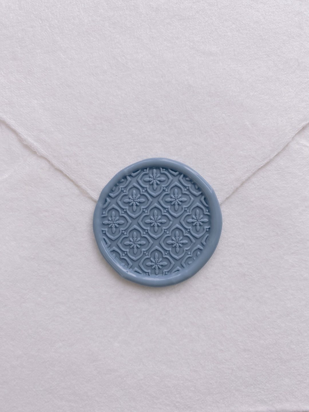 Moroccan tile pattern wax seal in dusty blue on beige handmade paper envelope
