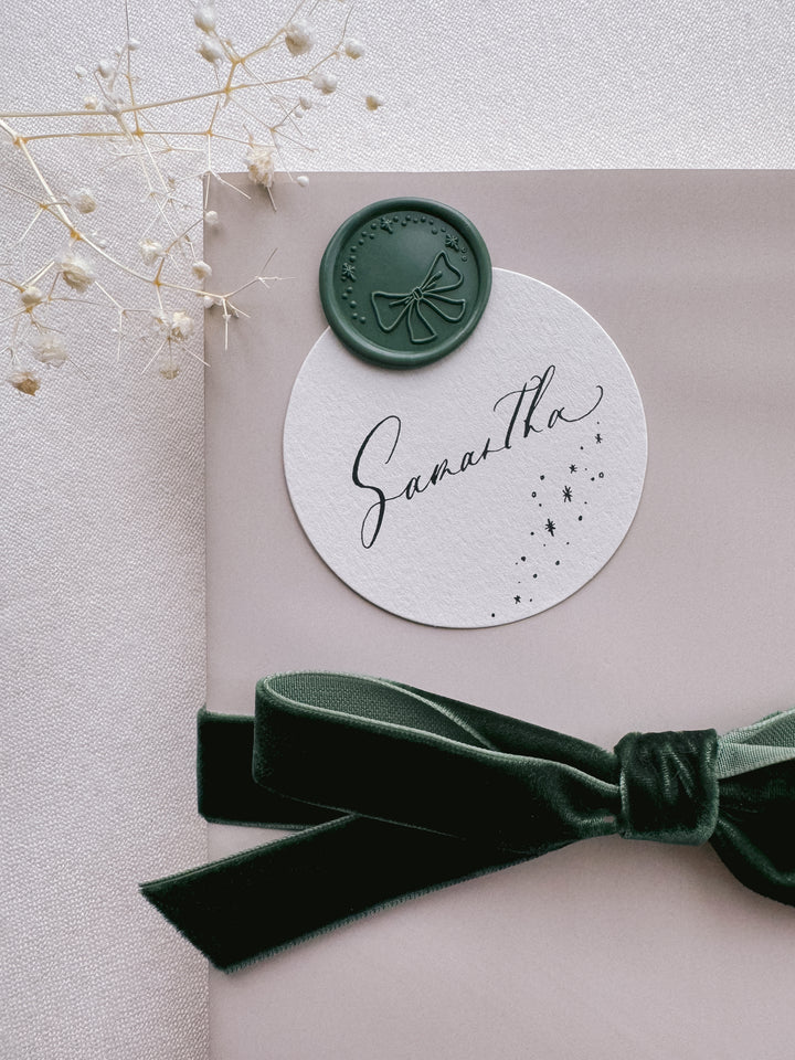 dark green festive Christmas wax seal on holiday gift wrap