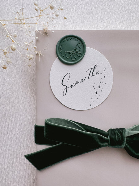 Christmas sparkles and ribbon bow green wax seal on holiday gift