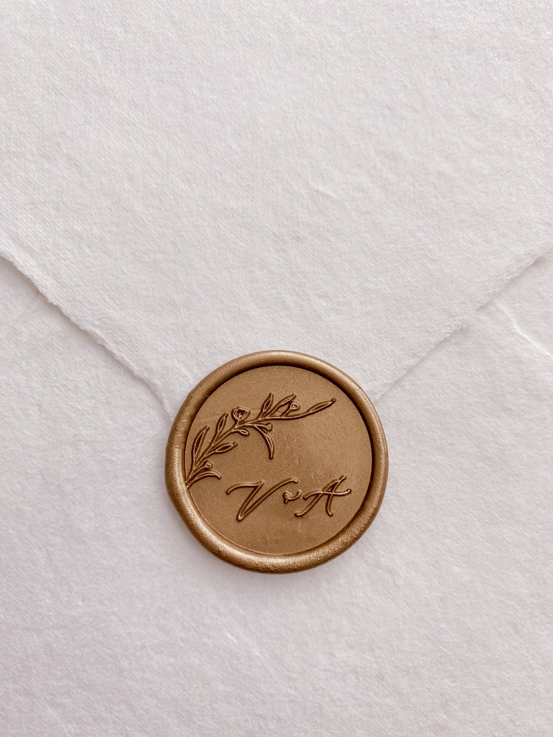 Floral branch monogram custom wax seal in gold on handmade paper envelope