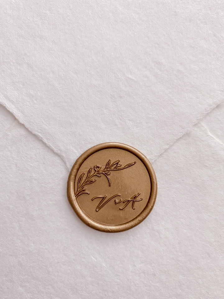 Floral branch monogram custom wax seal in gold on handmade paper envelope