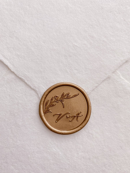 Floral blranch monogram wax seal in gold on handmade paper envelope