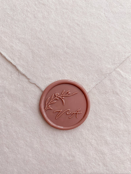 Floral branch monogram dusty rose custom wax seal with calligraphy script letters on beige handmade paper envelope