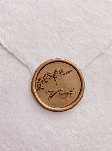Floral branch monogram gold custom wax seal with calligraphy script letters on beige handmade paper envelope