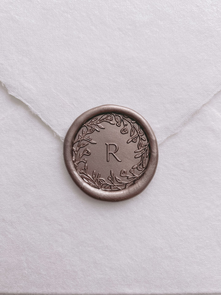Floral crown single initial custom wax seal in color mocha on a white handmade paper envelope