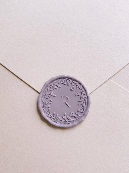 fFloral crown single initial custom wax seals in mauve on beige paper envelope