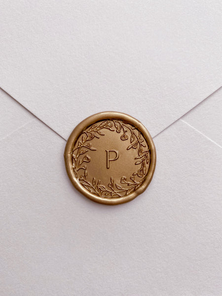 Floral crown single initial custom wax seals in gold on envelope close view