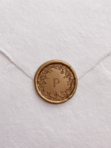 Floral crown single initial custom wax seals in gold on beige handmade paper envelope