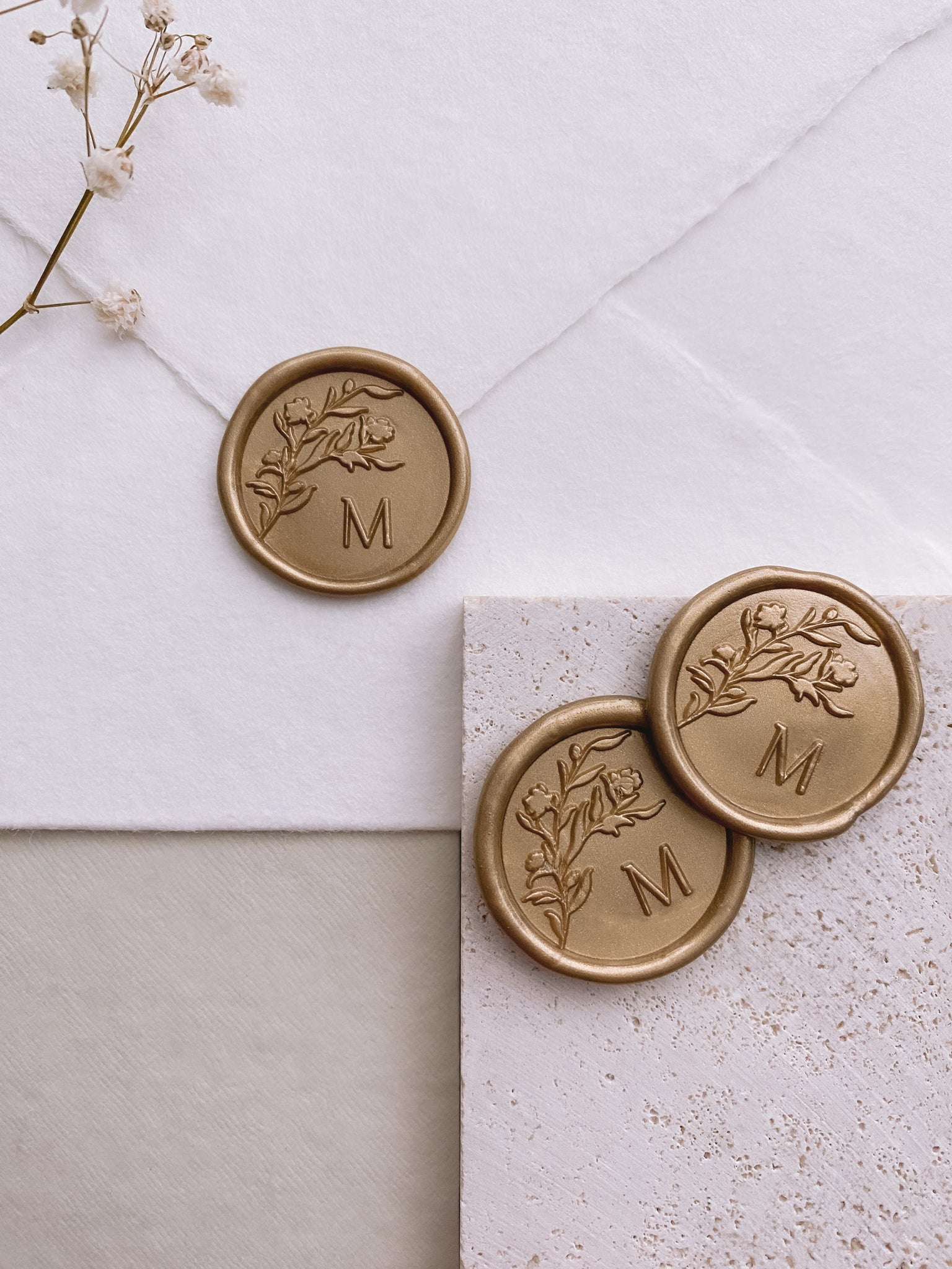 Floral silhouette monogram wax seals in light gold
