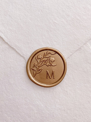 Floral silhouette single gold custom initial wax seal on beige handmade paper envelope