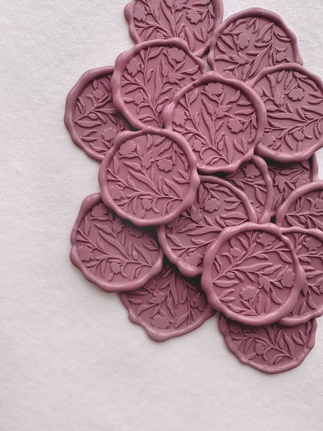 Dusty rose colored floral silhouette pattern wax seals