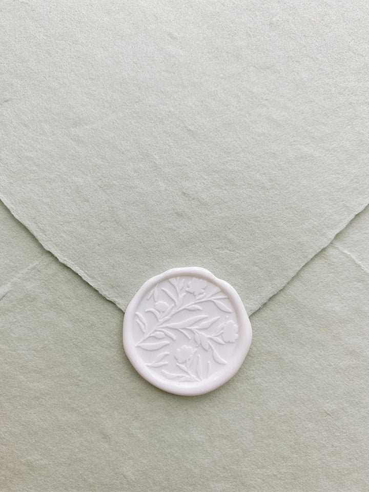 Floral silhouette wax seal in white on sage handmade paper envelope