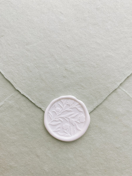 Floral silhouette wax seal in white on sage handmade paper envelope