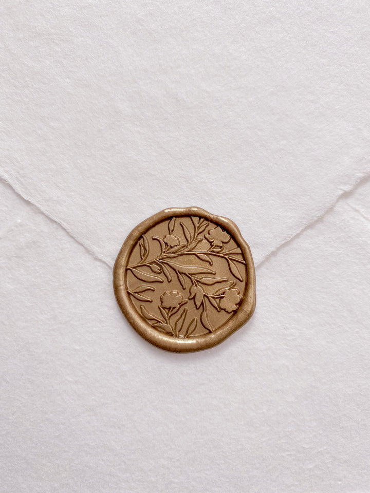 Floral silhouette wax seal in gold on white handmade paper envelope_front angle 