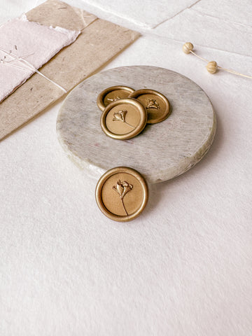 Mini flower gold wax seals with 3D engraving styled with a small gray stone dish, handmade paper and a dried floral branch