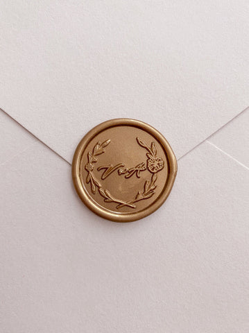 Floral leaf wreath monogram gold custom wax seal on beige paper envelope 