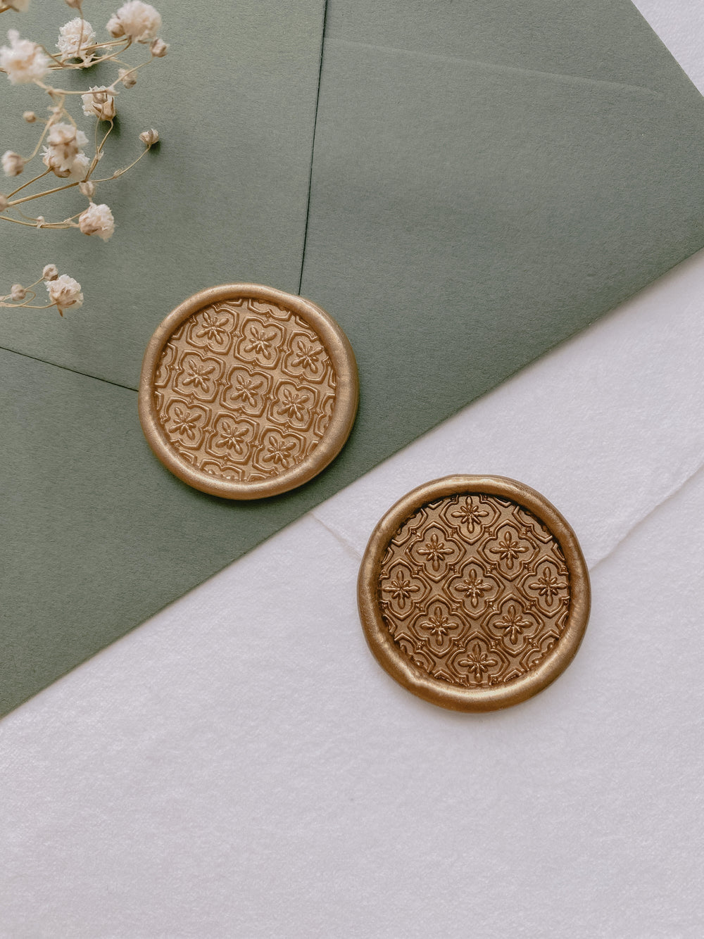 gold moroccan tile pattern round wax seals in gold on olive green and white wedding envelopes_front angle 