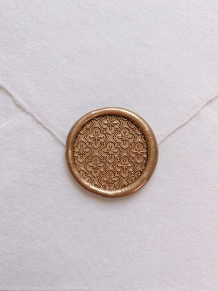 Moroccan tile pattern round wax seal in gold on handmade paper envelope_front angle