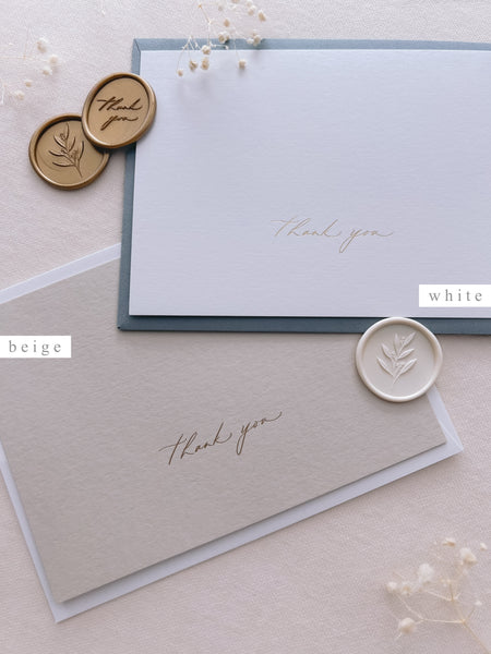 beige and white gold foil pressed thank you cards with white and gold wax seals