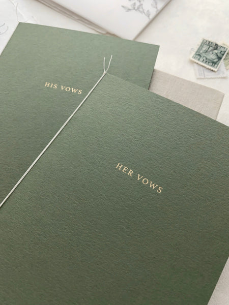 A set of two His and Her gold foil olive green card stock vow books in typeface font with fine white twine 