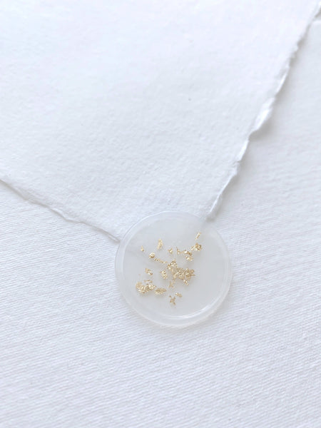 a gold leaf vellum wax seal on handmade paper envelope