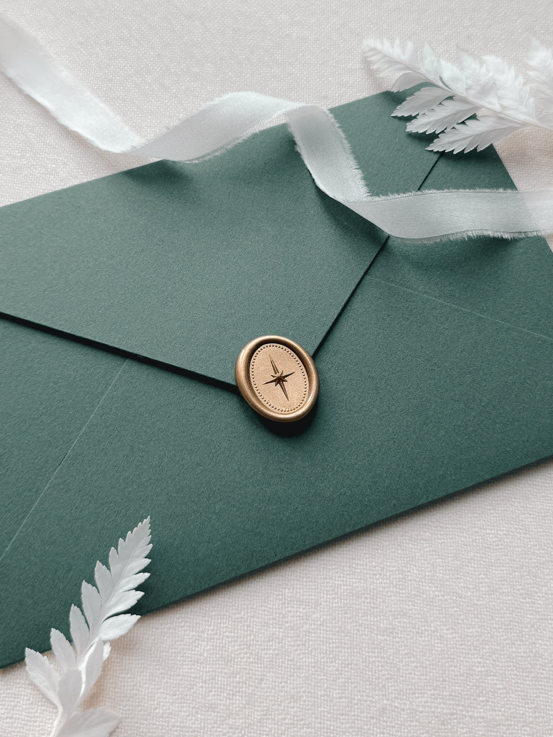 green envelope with mini oval North Star gold wax seal