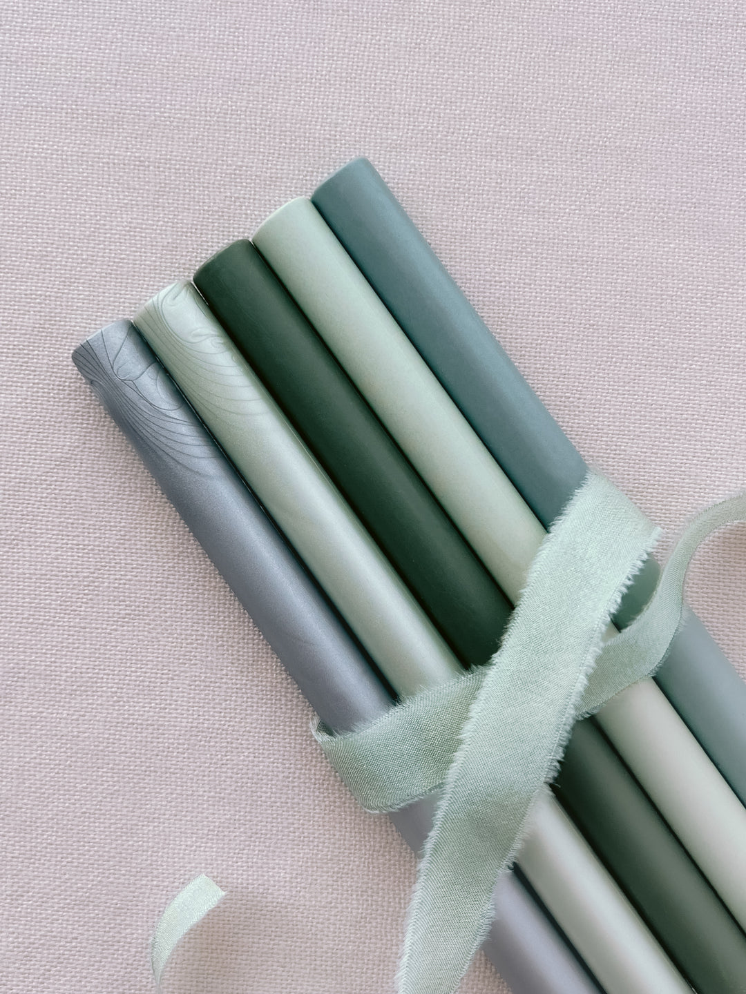 glue gun sealing wax sticks in various green colors and silver