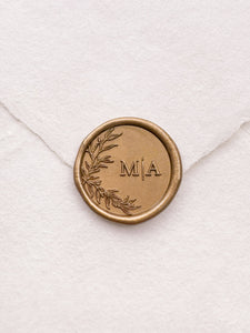 custom monogram gold wax seal with a botanical leaf design