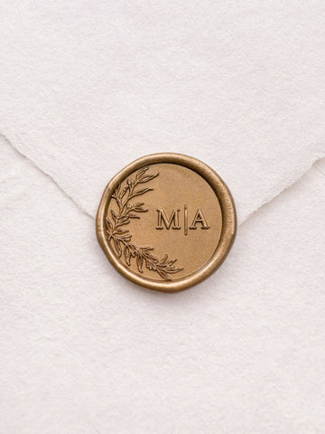 custom monogram gold wax seal with a botanical leaf design