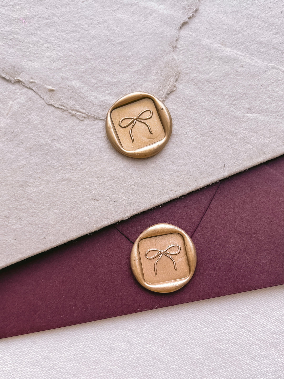 square shaped hand-drawn bow gold wax seals
